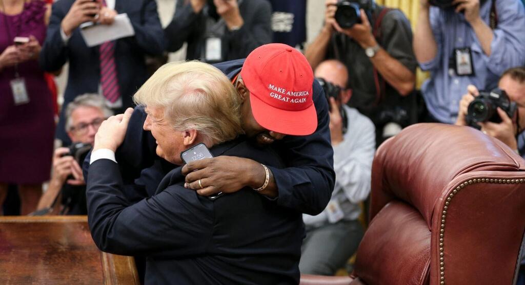 Rapper Kanye West hugs U.S. President Donald Trump during a meeting in the Oval office of the White House, Oct. 11, 2018