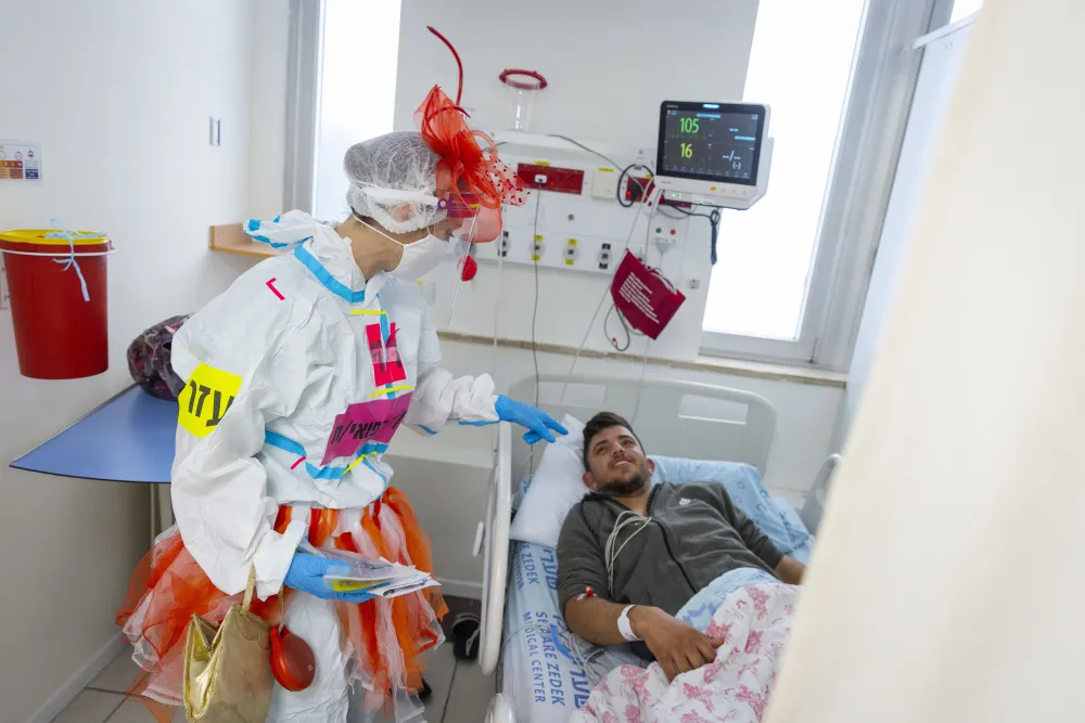 Rosie a medical clown wearing safety gear visits patients in the coronavirus ward of Shaare Zedek hospital in Jerusalem 