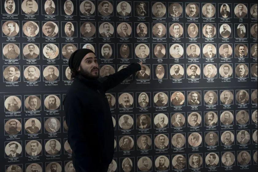 Tour guide Arek Kahkedjian gestures to a display on the Armenian genocide in the Armenian Museum in the Old City of Jerusalem, Wednesday, Jan. 11, 2023