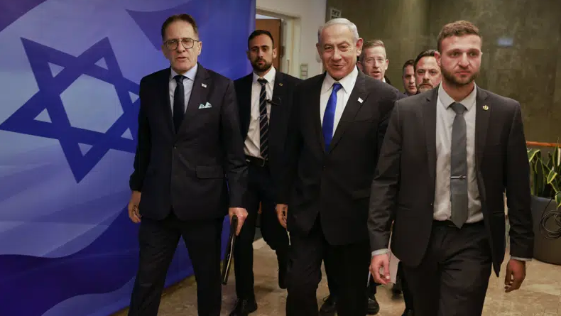 Israeli Prime Minister Benjamin Netanyahu, center, arrives for a weekly cabinet meeting at the Prime Minister's office in Jerusalem on Sunday, Jan. 15, 2023 