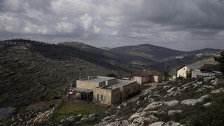 Houses sit on a hill at the West Bank settlement outpost of Givat Harel