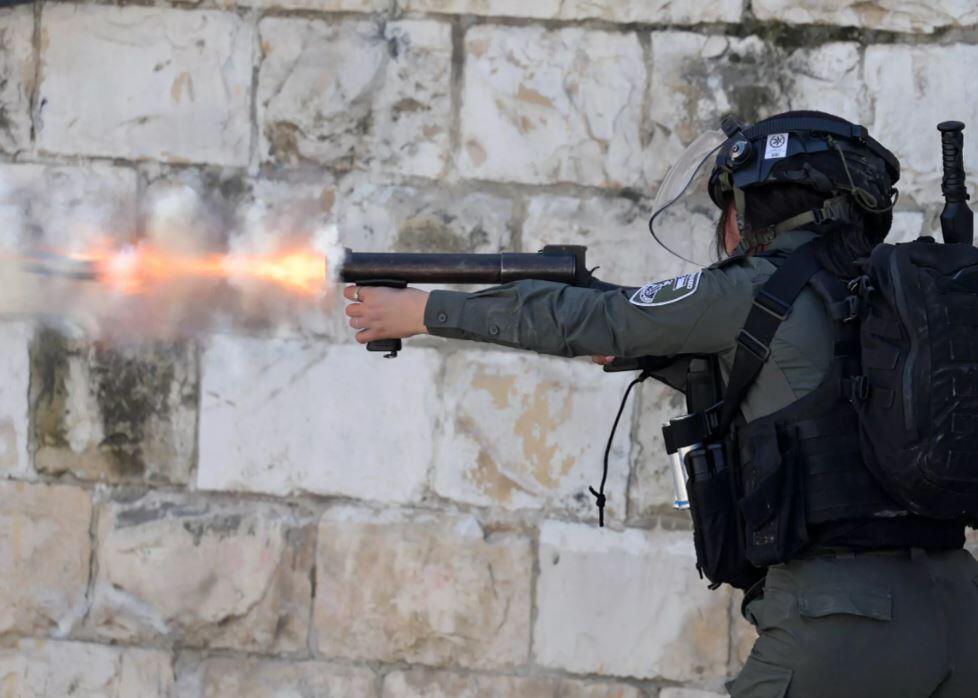 A member of the Israeli security forces uses tear gas to disperse Palestinians demonstrating against the demolition of houses by Israeli authorities in the Arab neighbourhood of Silwan in Israeli-annexed east Jerusalem, on March 3, 2023