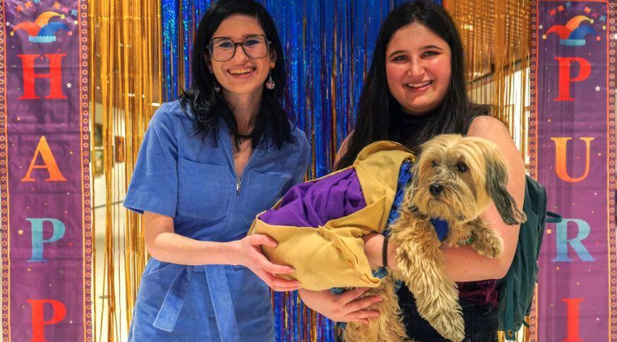 Sisters Rebecca, left, and Liz Karpen with their Havanese, Allen, in a homemade hamantaschen costume