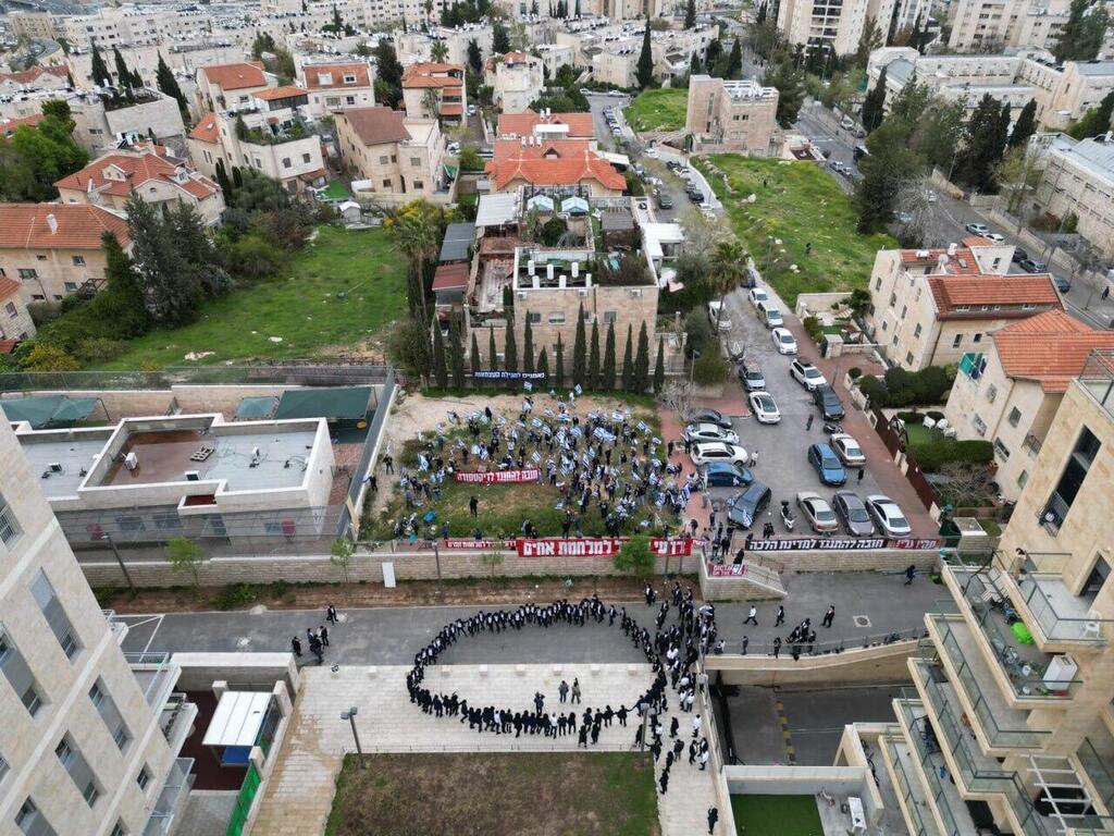 Drone shot of an anti-judicial reform protest and Haredi counter-protest in front of ousted minister Arye Deri’s Jerusalem home 