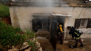  Firefighters work at a Palestinian house which Palestinians say was attacked by Israeli settlers near Ramallah in the Israeli-occupied West Bank, March 26, 2023 