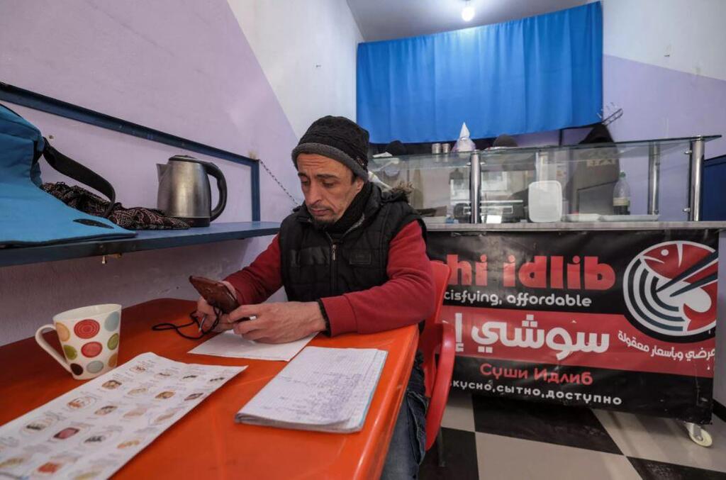 Shakhbanov sits in his 'Sushi Idlib' restaurant, which he says he was inspired to open after sampling Japanese cuisine during his travels