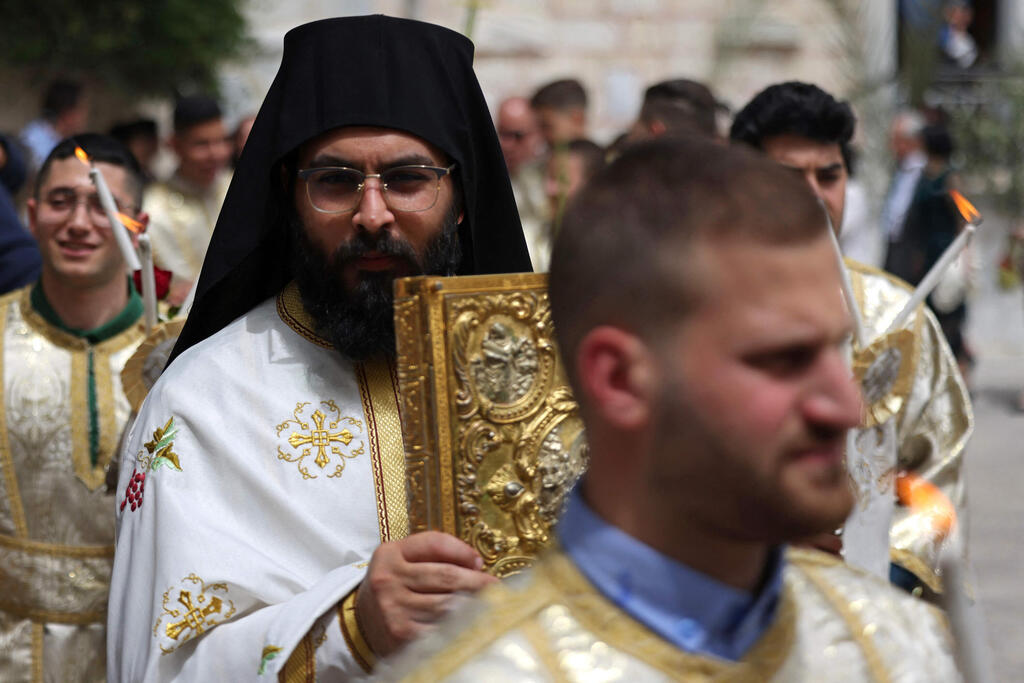 Orthodox clergymen hold the Palm Sunday procession in Gaza City on April 9, 2023 