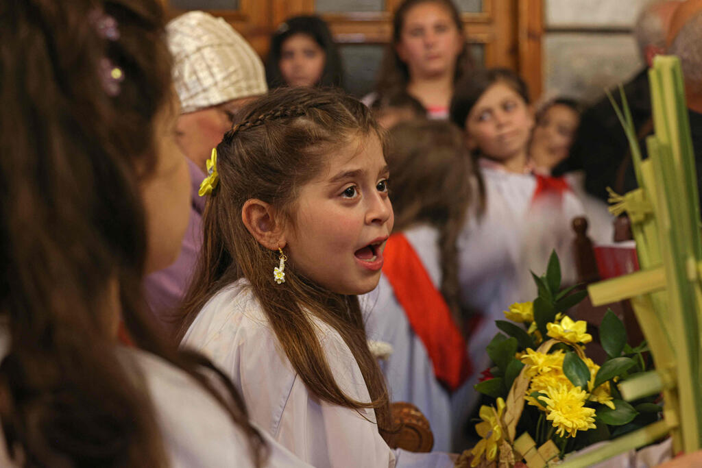 Palestinian Orthodox attend the Palm Sunday mass at a church in Gaza City on April 9, 2023 