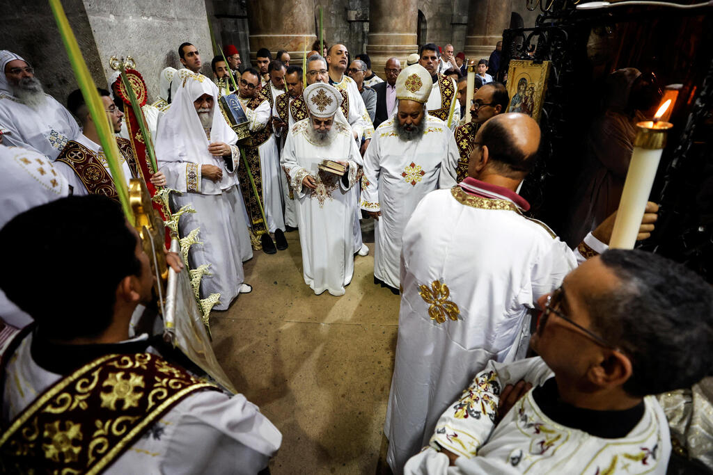Coptic Christians participate in a procession during Orthodox Palm Sunday, marking the start of Holy Week that ends on Easter Sunday in the Church of the Holy Sepulcher in Jerusalem's Old City, April 9, 2023 