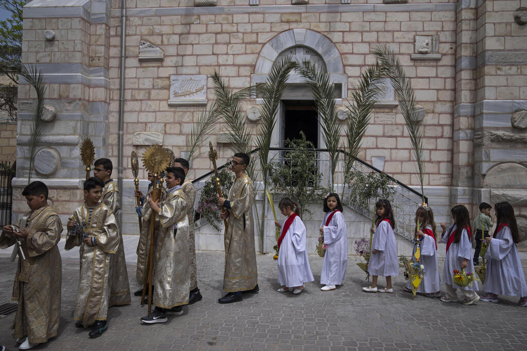 Palestinian Christians attend Palm Sunday mass in a Greek Orthodox church in Gaza City, April 9, 2023