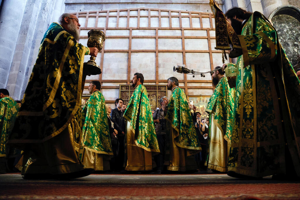 Greek Orthodox priests lead a procession during Orthodox Palm Sunday, marking the start of Holy Week that ends on Easter Sunday in the Church of the Holy Sepulcher in Jerusalem's Old City, April 9, 2023 