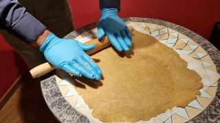 Avi Yefet, caretaker of the Karaite synagogue, rolls out dough to make 'massa' for Passover 