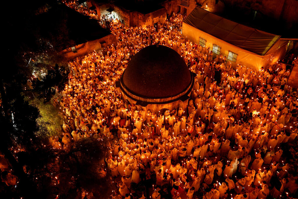 Ethiopian Orthodox worshippers hold candles during the Holy Fire ceremony 