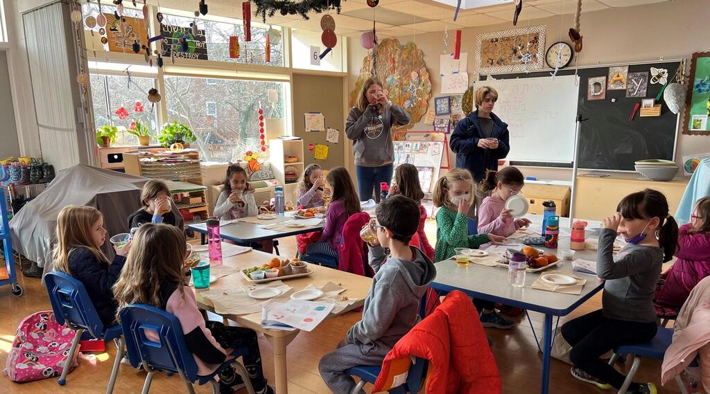 Teens lead a Tu Bishvat seder with a group of first graders