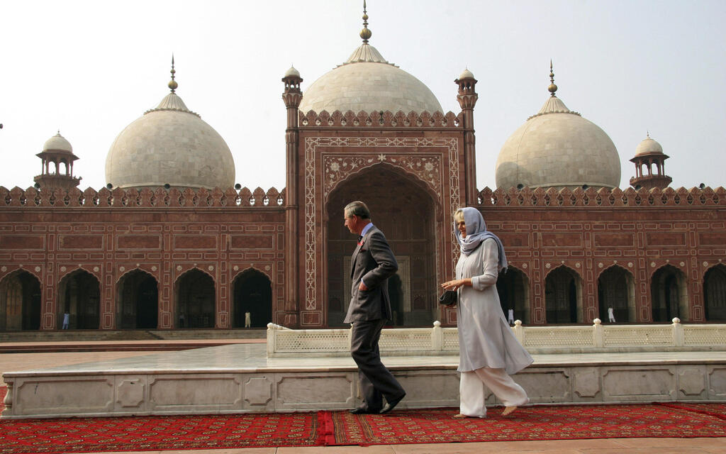 Britain's Prince Charles and his wife Camilla stroll around historical Badshahi mosque in Lahore, Pakistan