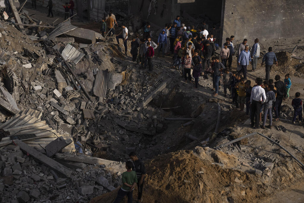 Residents of northern Gaza view the aftermath of an Israeli strike on a PIJ commanders home on Friday 