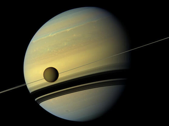 Titan and another 144 moons. For now. Saturn's large moon against the backdrop of the planet and its rings in a photograph by the Cassini spacecraft 