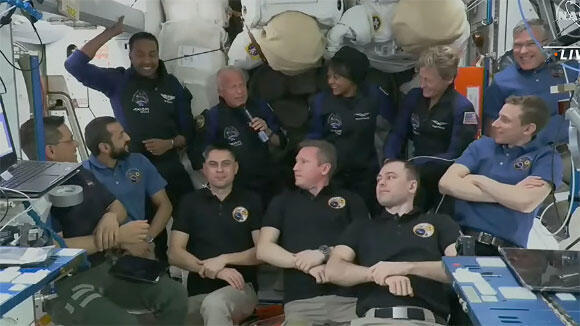Not only is the station full, but the parking lot is also crowded. The seven regular crew members with the four guests from the private mission