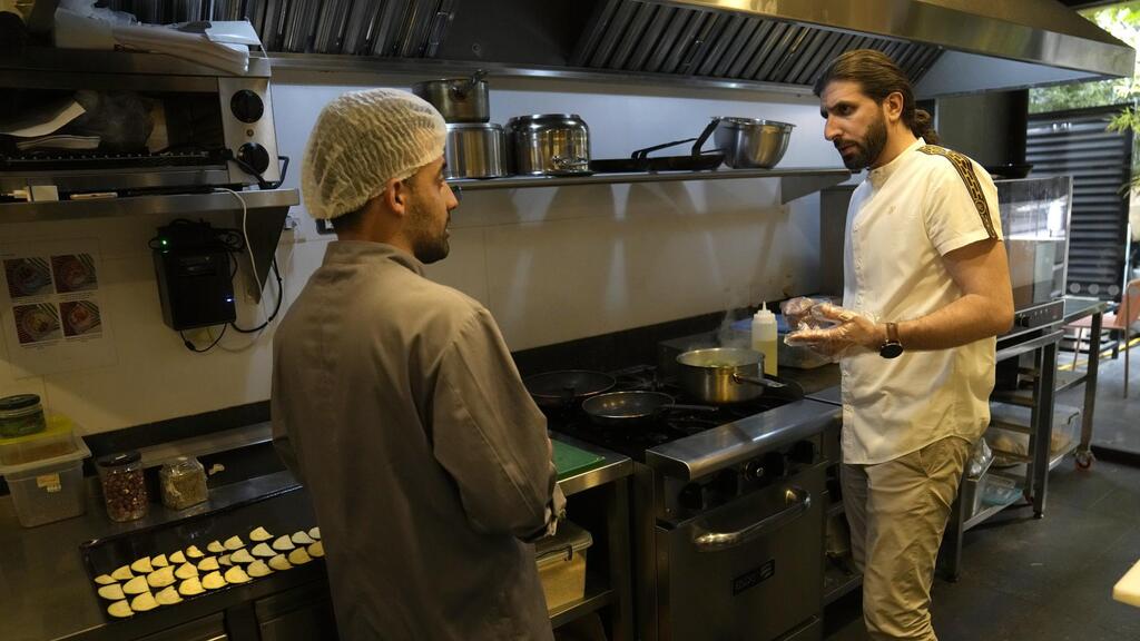 Abbas Bazzi gives directions to a chef at Le Marché Bio, the organic cafe and grocery store he co-owns, in Beirut, Lebanon 