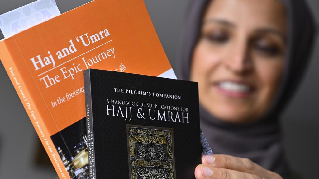 Muslim family member Saadiha Khaliq holds material which she read in preparing for her upcoming trip to hajj 