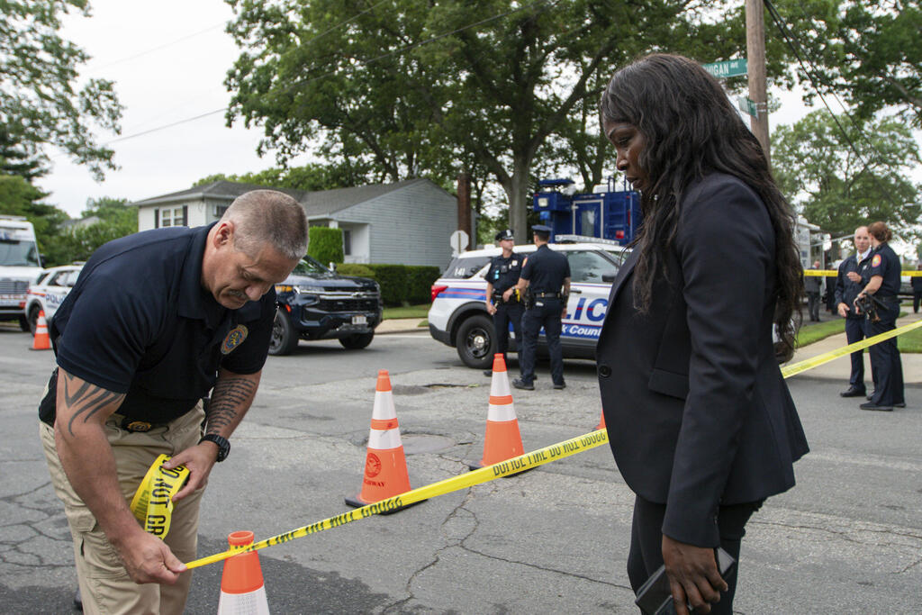 Police officers secure the area near the house where a suspect has been taken into custody on New York's Long Island in connection with a long-unsolved string of killings, known as the Gilgo Beach murders, Friday, July 14, 2023, in Massapequa Park, N.Y.