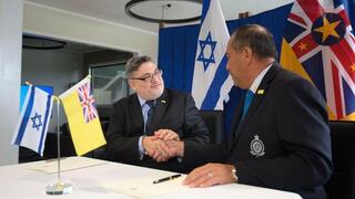 ראש ממשלת ניואה דלטון טאגלאגי חותם על המסמך עם רן יעקובי, שגריר ישראל לניו זילנד