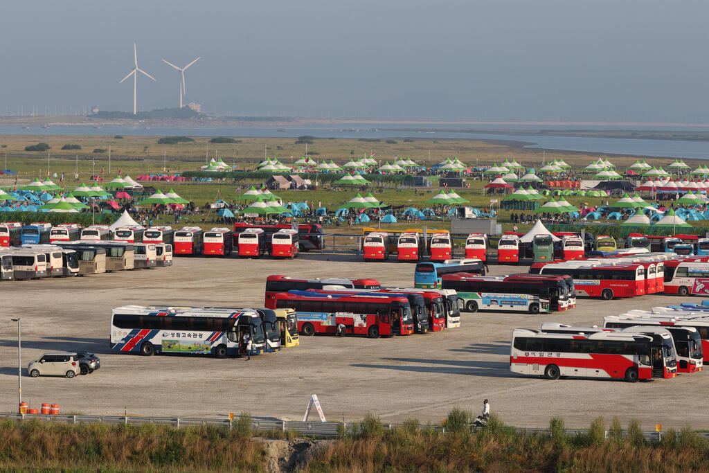 Buses are parked at the World Scout Jamboree campsite in Saemangeun 