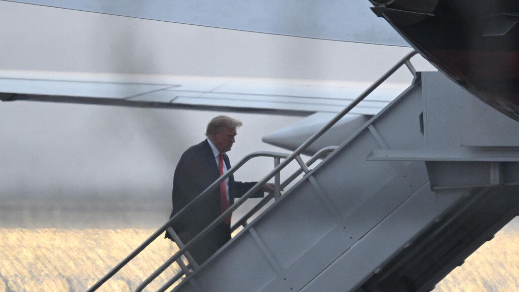 Donald Trump boards his plane after being arrested in Georgia on Thursday 