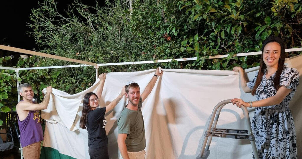 The Cohen family build a sukkah