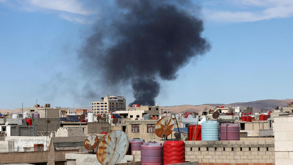 Smoke rises from Syria's Kurdish-controlled northeast city of Qamishli, Syria