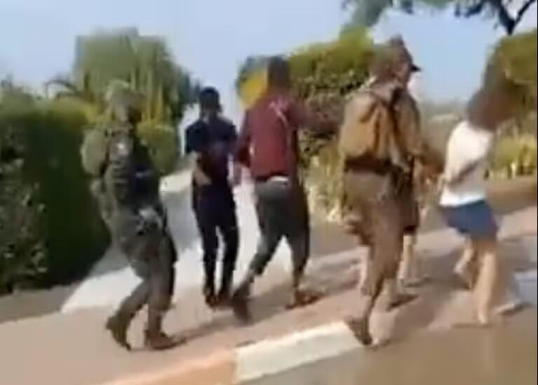 Hamas militants move Israeli hostages down a street in Be’eri, a kibbutz in southern Israel, video posted to X shows 