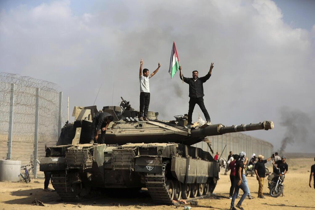 Terrorists celebrate capture of an IDF tank 