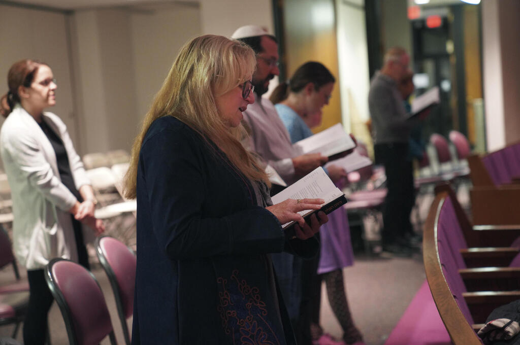 Suzi Neft, center, and congregants of Temple Sinai sing during a Shabbat service Friday, Oct. 13, 2023