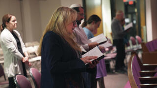 Suzi Neft, center, and congregants of Temple Sinai sing during a Shabbat service Friday, Oct. 13, 2023