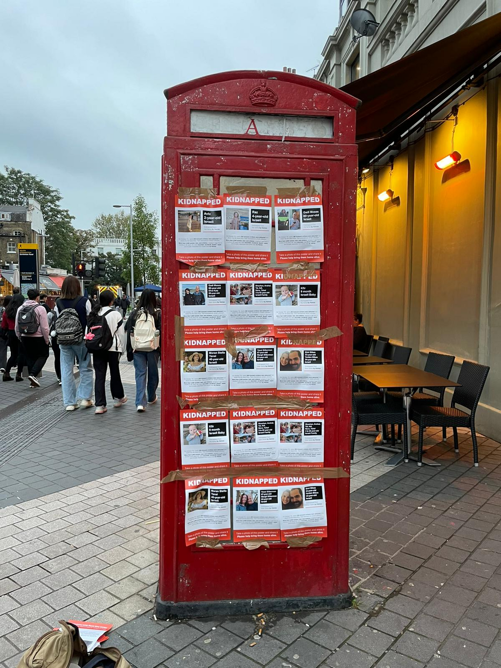 London telephone booth covered in posters with names and photos of Israeli abducted to Gaza by Hamas 