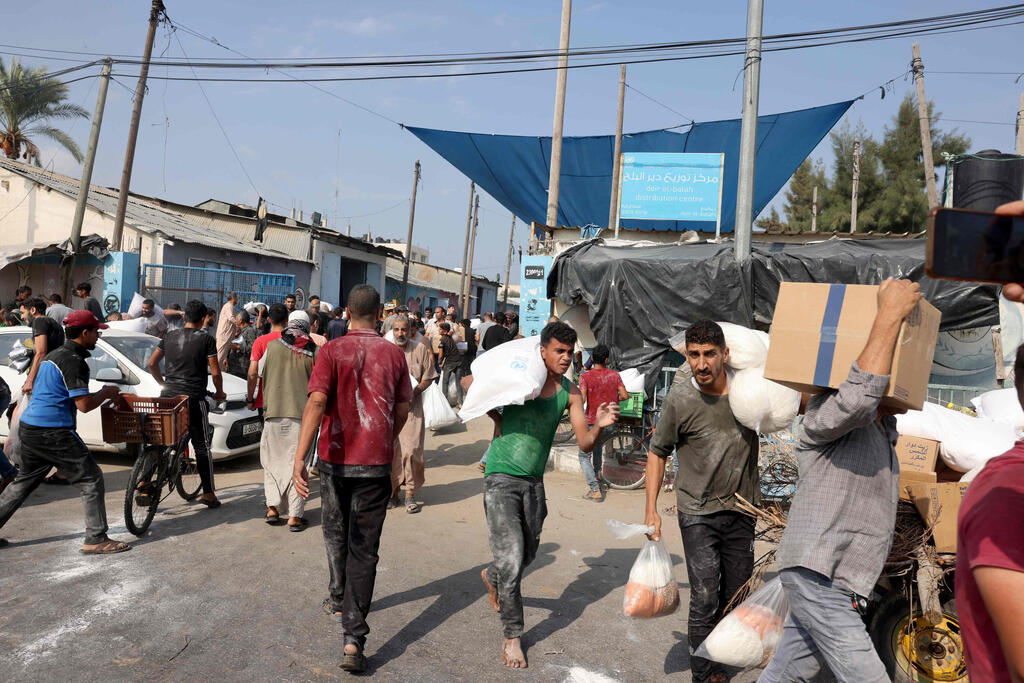 Gaza residents take supplies from breached UNRWA stores 