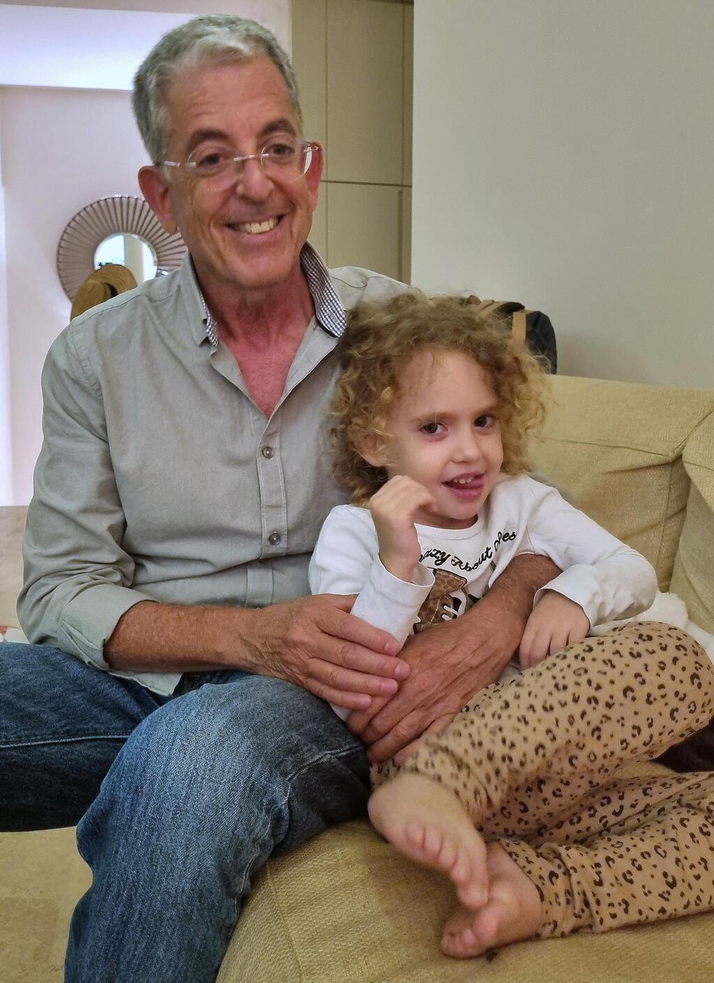 Aviv Havron with little Yahel after she was released from Hamas captivity in Gaza 