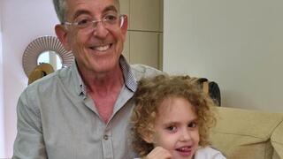 Aviv Havron with little Yahel after she was released from Hamas captivity in Gaza 