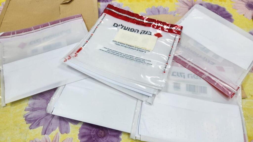 Конверты для наличных (Фото: полиция округа Амаким) רכב המרצדס וטפסי הבנק הפועלים שהיו ברשות החשודים