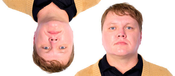 Which face looks thinner? Images of the same person, upright and inverted