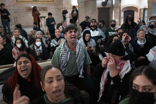 Pro-Palestine demonstrators rally in the lobby of Chicag City Hall