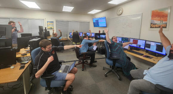 The telescope’s control room team celebrates as it managed to successfully lock onto the satellite's laser
