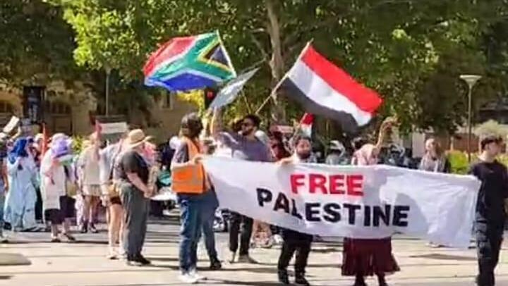 Pro-Palestinian protesters march with South Africa and Yemen flags