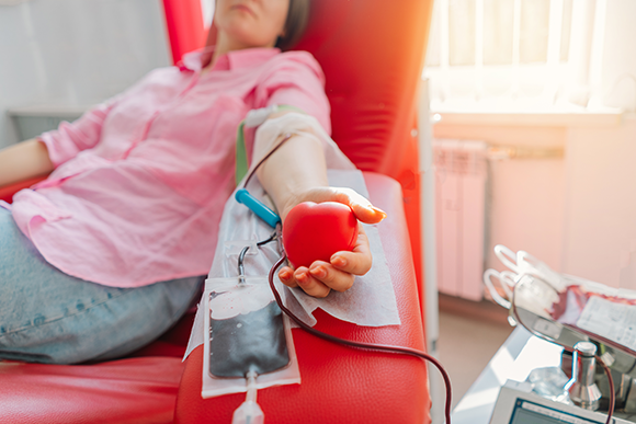 One of the treatments for blood component deficiency is blood transfusion: transferring blood or some of its specific fractions from a donor to a recipient. A woman donating blood 