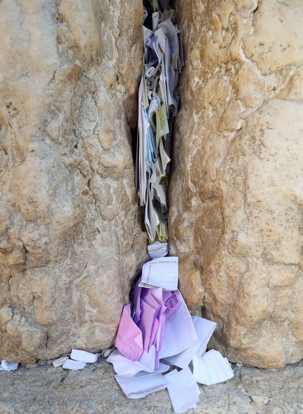 Notes and prayers clog the spaces between the stones of the Western Wall