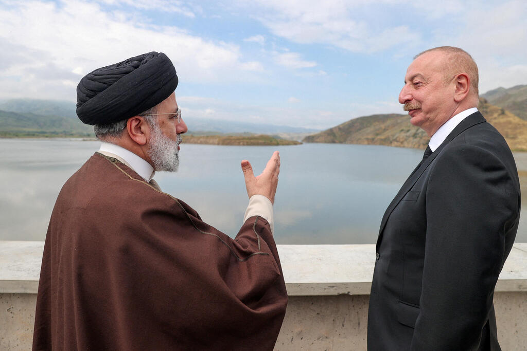Iranian President Ebrahim Raisi and Azerbaijan's President Ilham Aliyev visit the Qiz-Qalasi dam on the Azerbaijan-Iran border