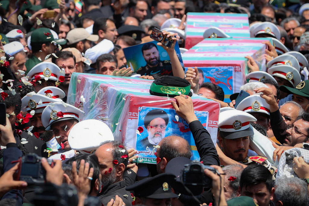 Mourners carry the coffin of late Iranian President Ebrahim Raisi, during his burial ceremony in Mashhad