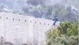 Palestinian man seen climbing over border wall from the West Bank 