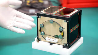 World's first wooden satellite LignoSat shown during a press conference at Kyoto University in Kyoto on May 28, 2024 