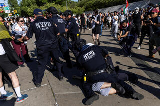 A pro-Palestinian protester is tackled and detained by New York City Police officers in front of the Brooklyn Museum during pro-Palesitnian protest on May 31, 2024. 